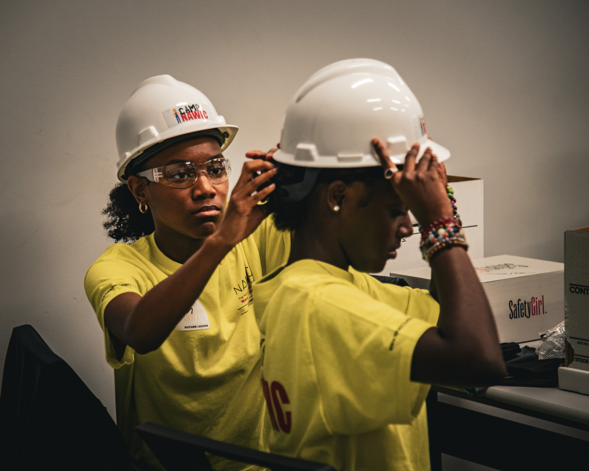 Campers in PPE using tools